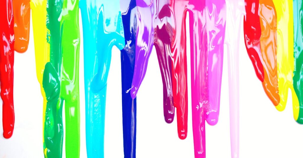 Bright, colorful paints dripping creating a rainbow effect on a white background, symbolizing diversity and creativity.